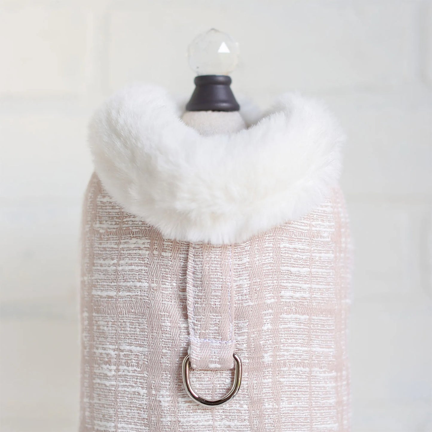 White fur scarf on a mannequin with a plain background