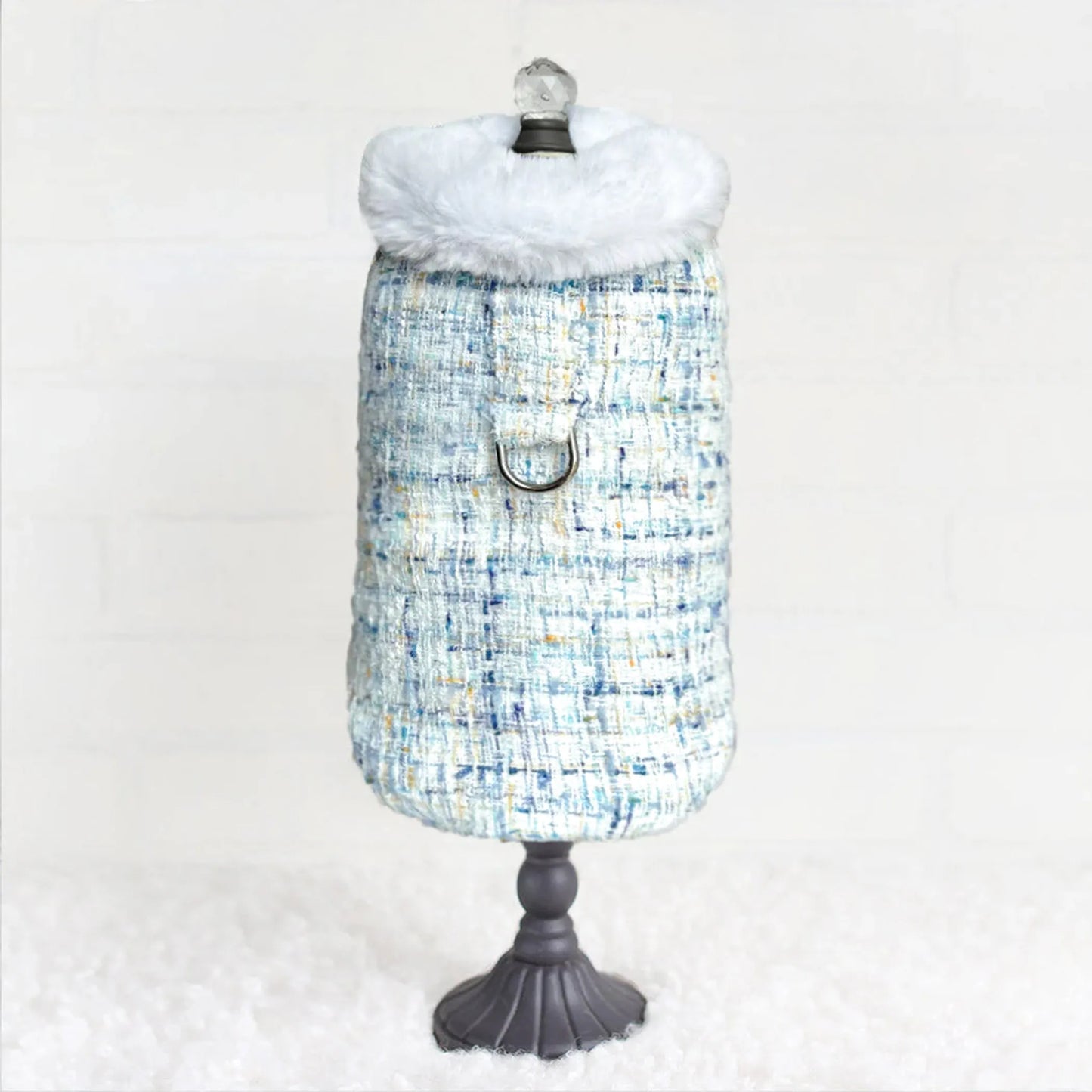Dog coat with a checkered pattern on a mannequin against a white background