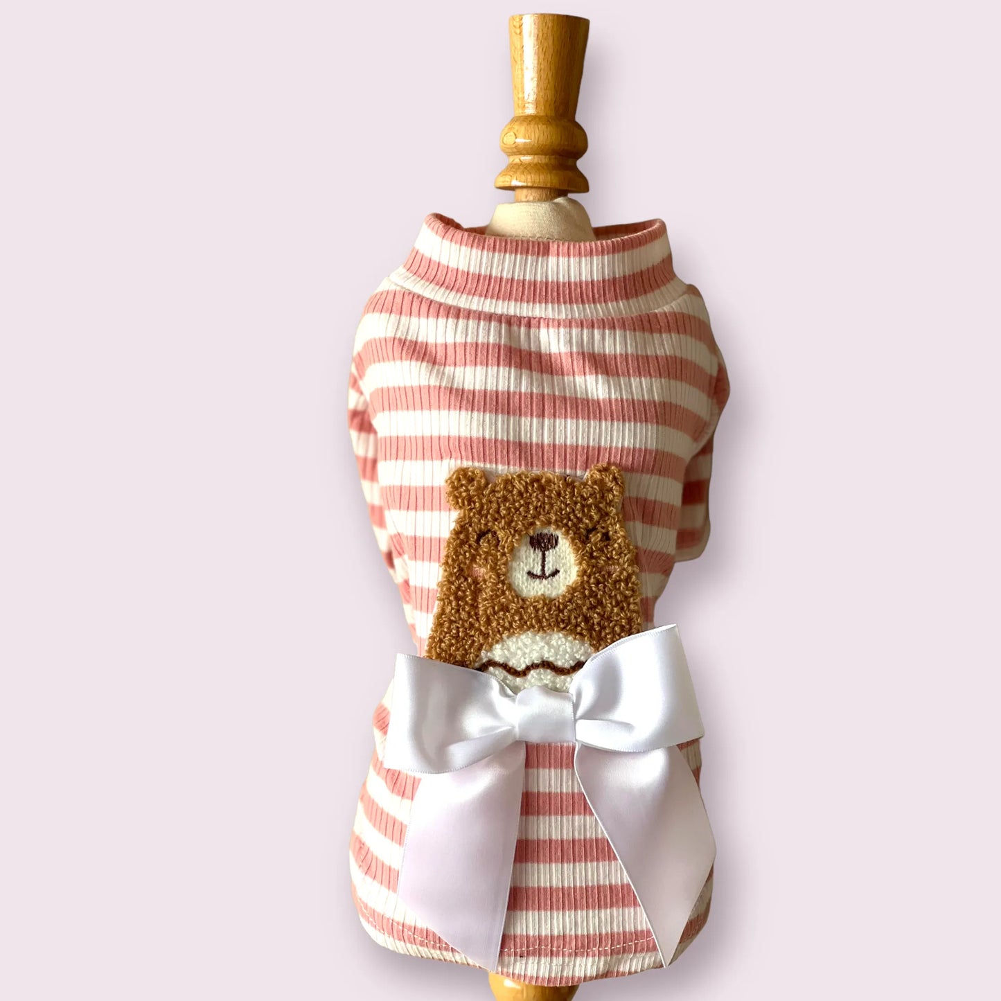Dog outfit with striped pattern and teddy bear design on a mannequin against a white background