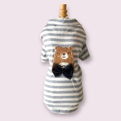 Striped pet dress with bear design and bow tie on a mannequin against a light purple background