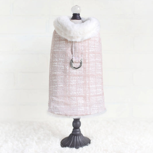 Mannequin wearing a textured dress with a white fur collar on a white background