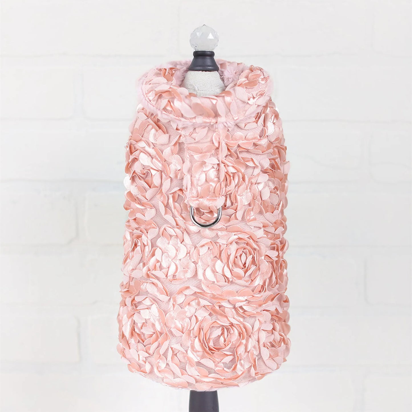 Pink floral dress on a mannequin against a white background