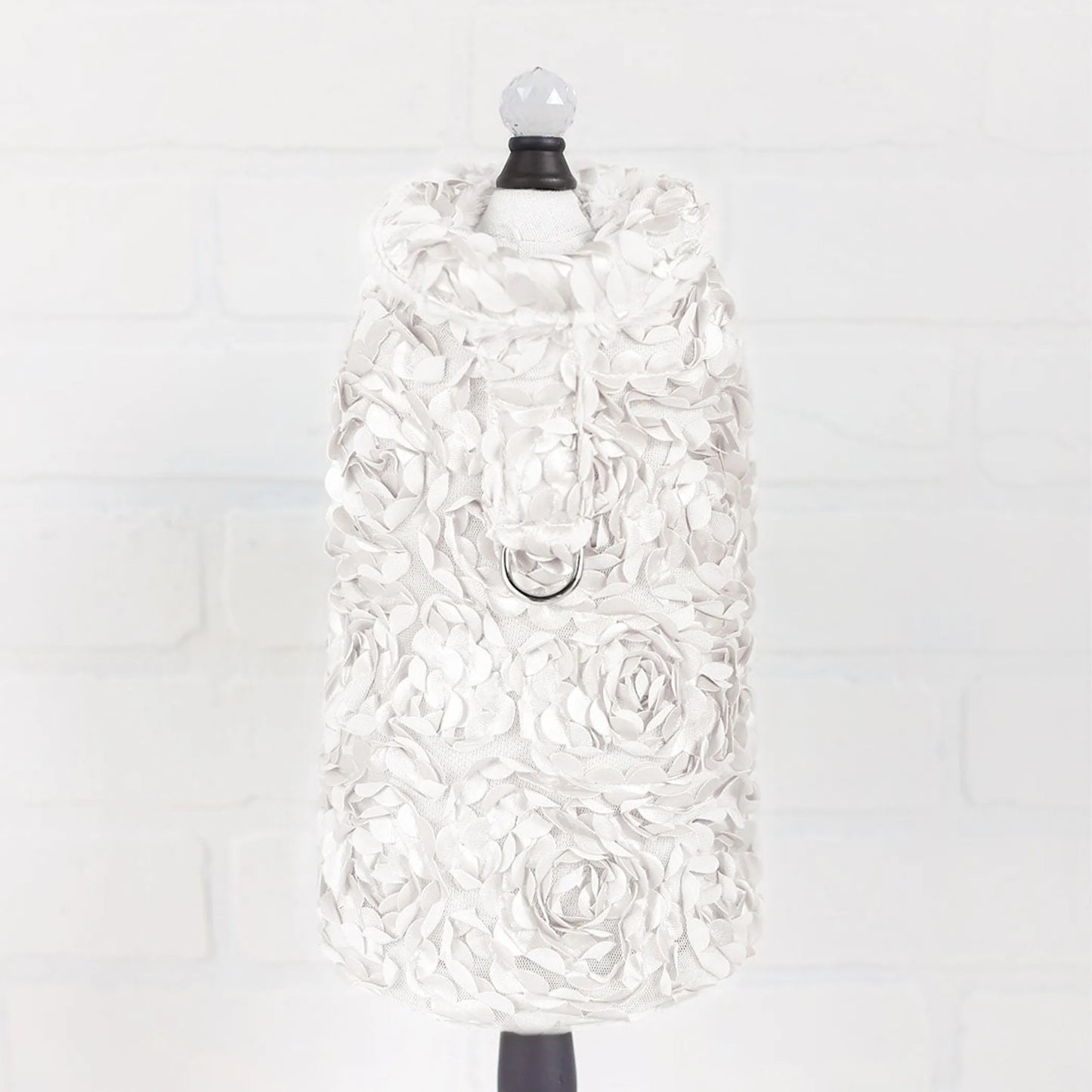 White floral dress on a mannequin against a white background