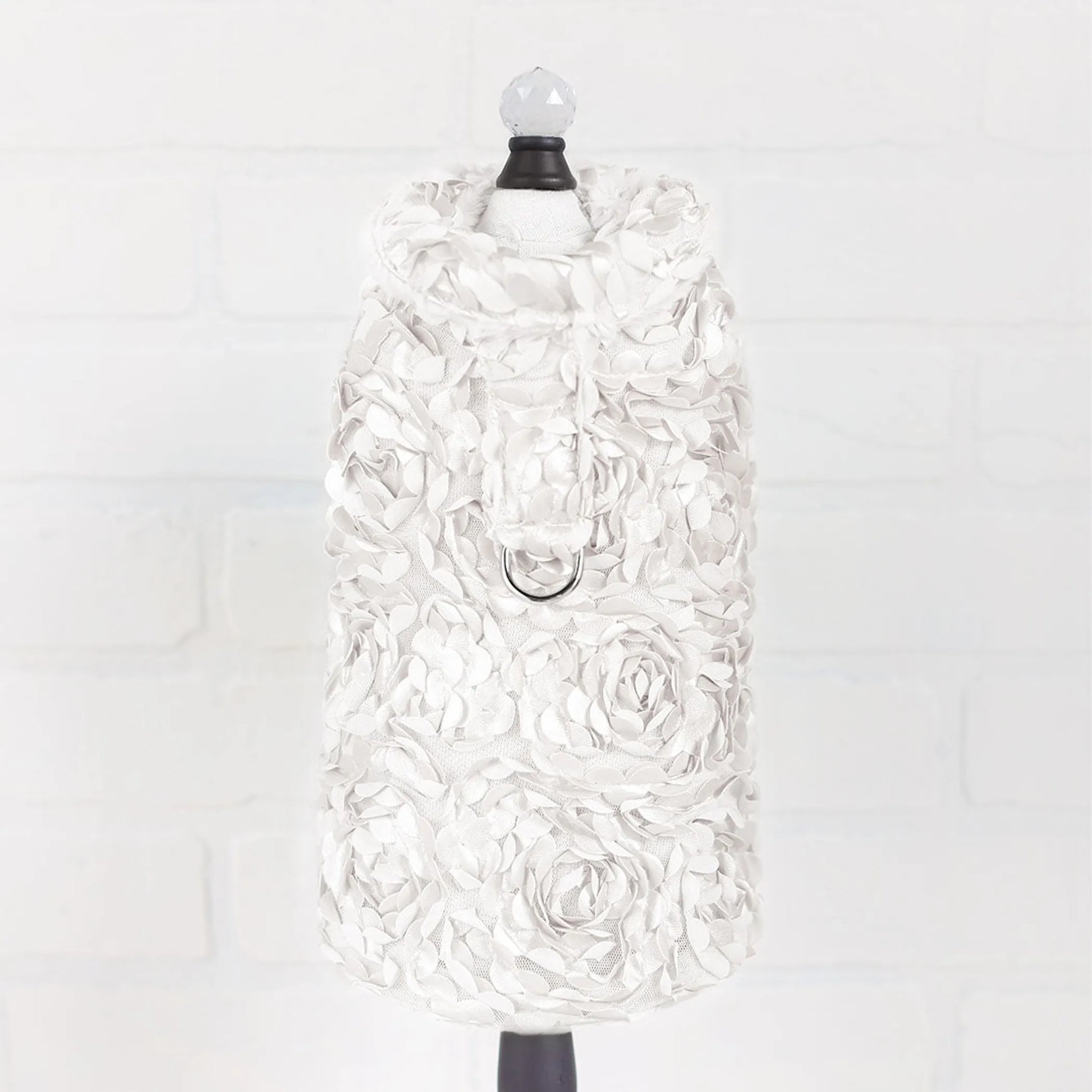 White floral dress on a mannequin against a white background