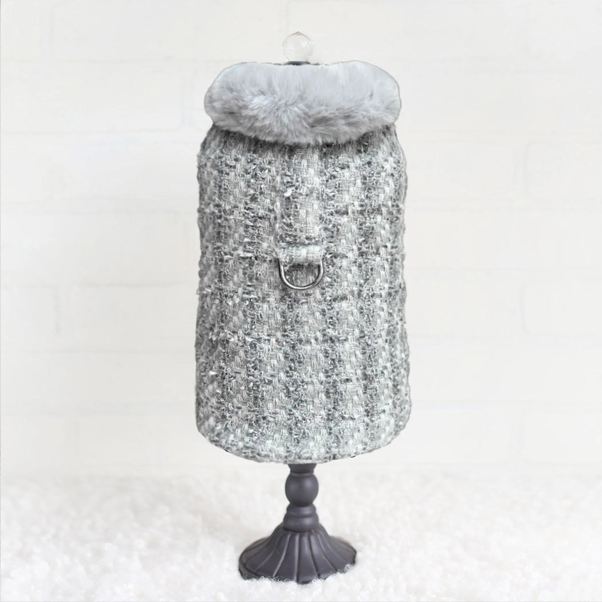 Mannequin wearing a textured gray coat with a fur-lined hood on a white background