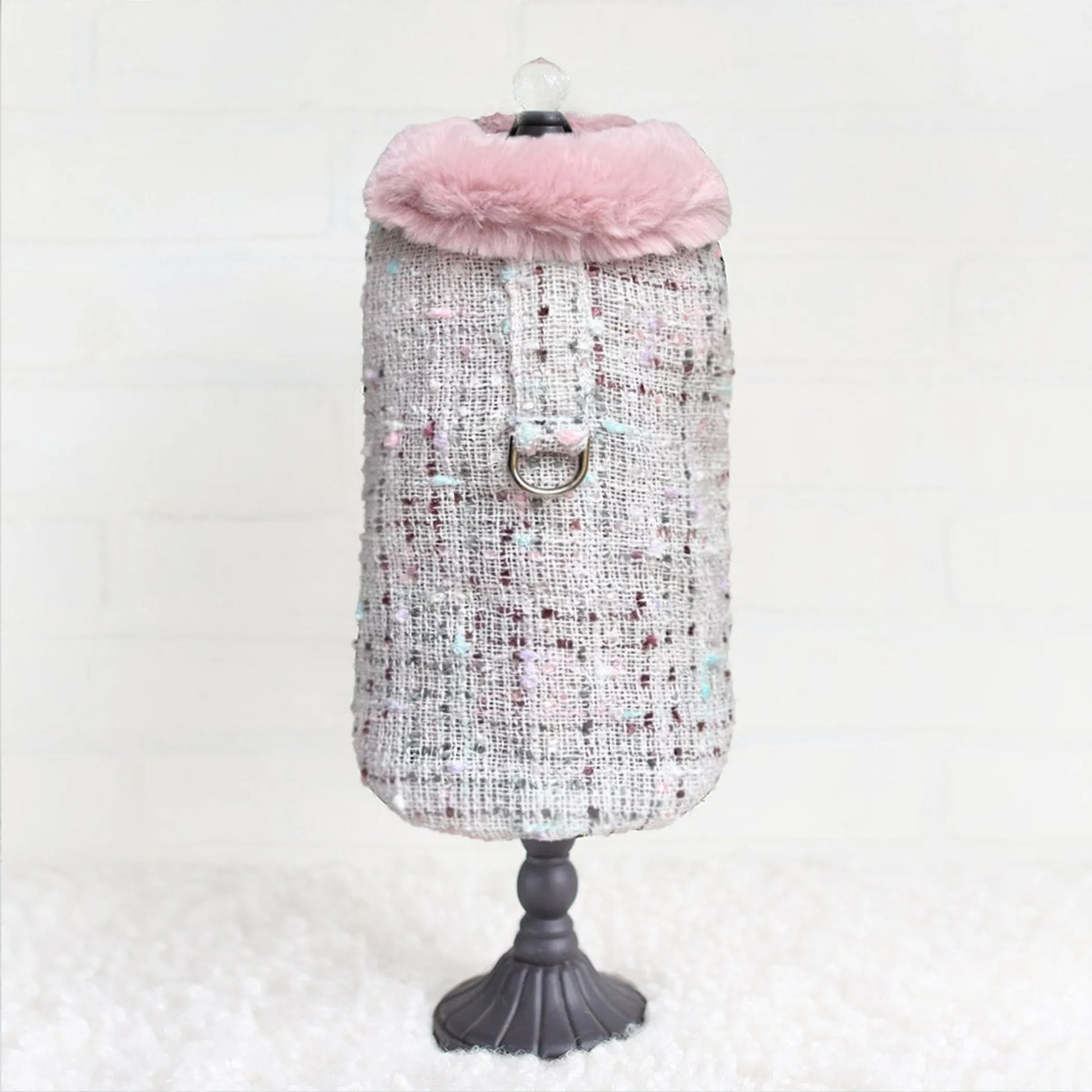 Dog coat with pink hood on a mannequin against a white background
