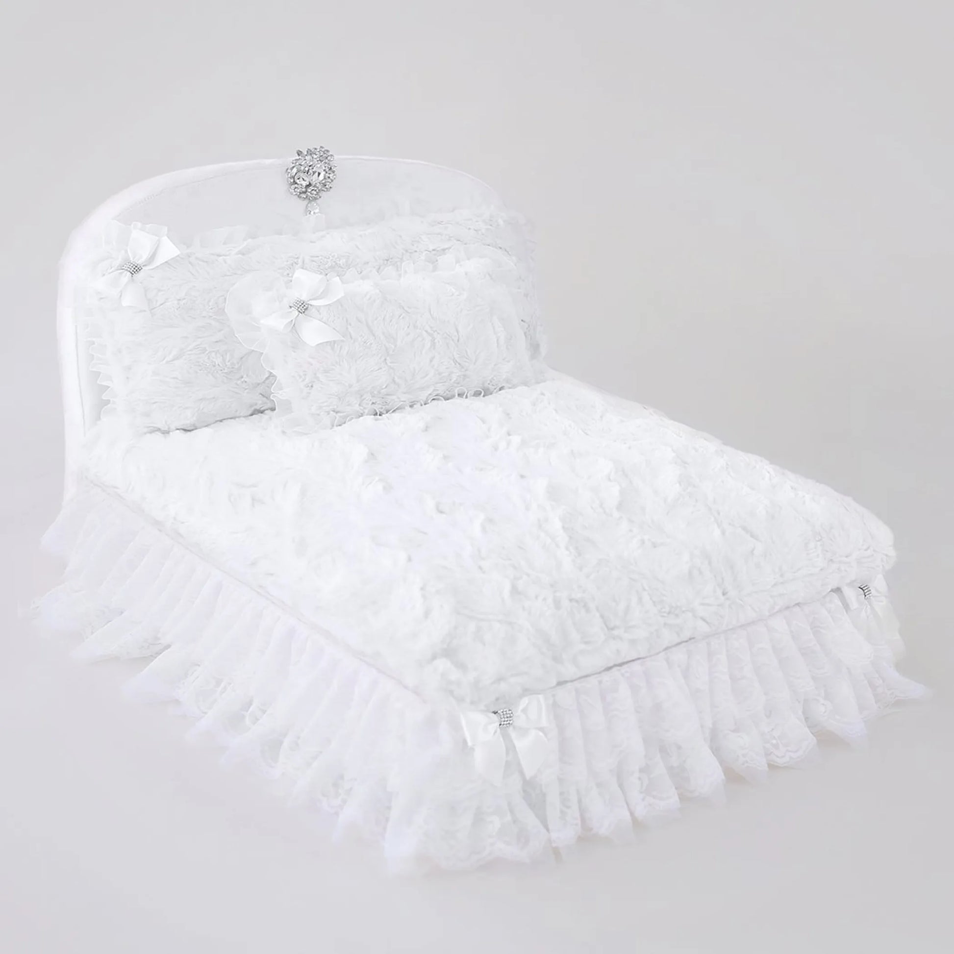 White feathered headpiece with decorative elements on a light gray background