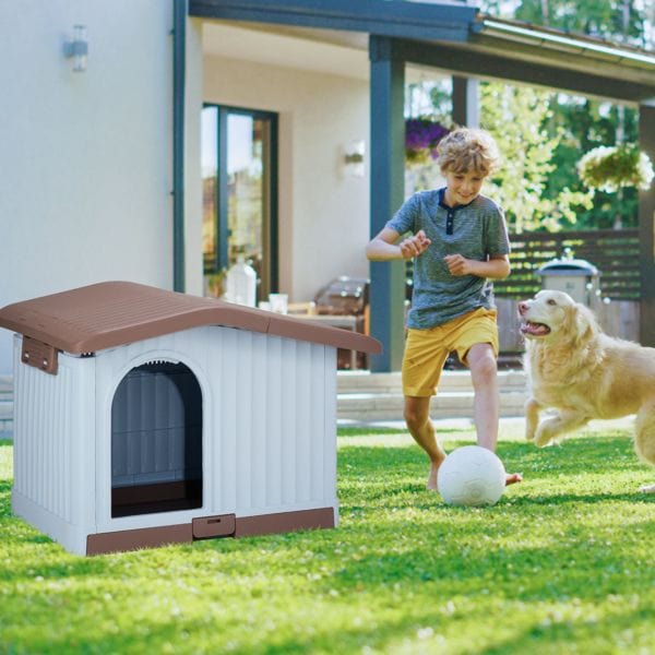 34 inch Large Plastic Dog House with Liftable Roof, Indoor Outdoor Doghouse Puppy Shelter with Detachable Base and Adjustable Bar Window, Brown & White In yard view